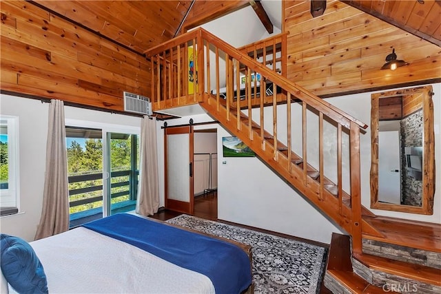 bedroom with dark hardwood / wood-style flooring, wood ceiling, a barn door, and high vaulted ceiling