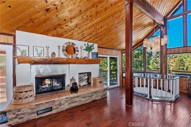 sunroom with vaulted ceiling with beams, a fireplace, and wooden ceiling