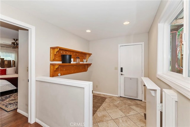 interior space with ceiling fan and light tile patterned floors