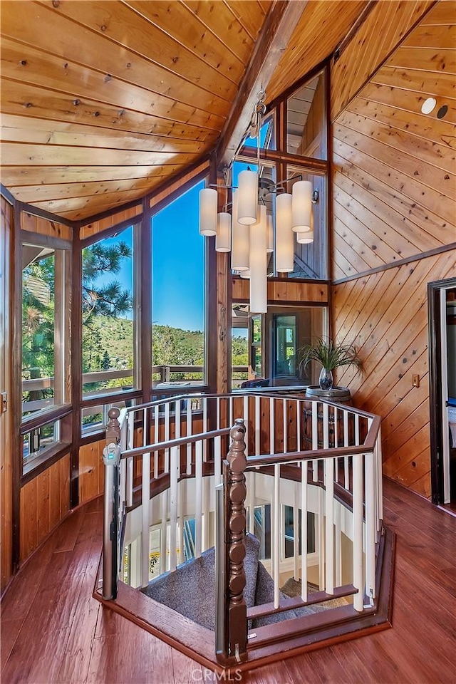 unfurnished sunroom featuring wood ceiling and vaulted ceiling with beams