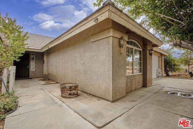 exterior space featuring a patio and a garage