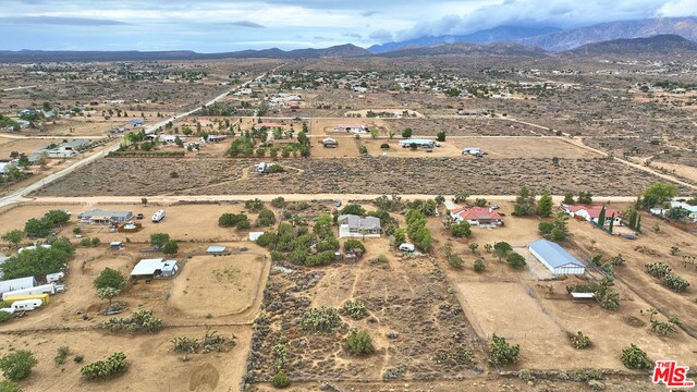 birds eye view of property with a mountain view