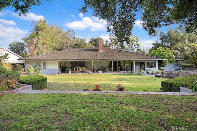 back of house with a patio area and a yard