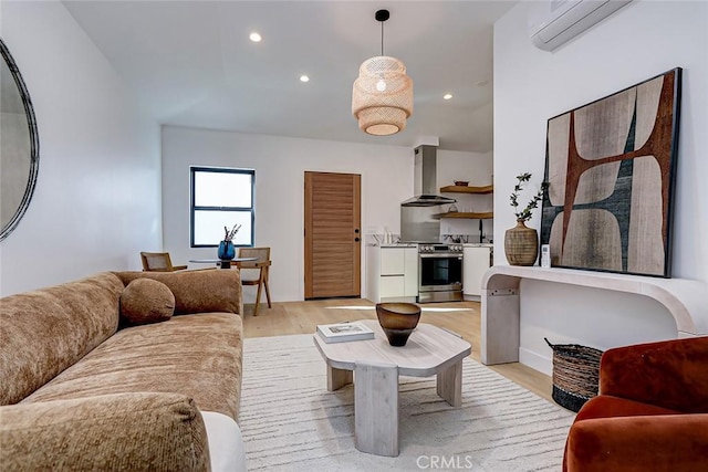 living room featuring light wood-type flooring and a wall mounted AC