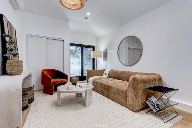 living room with light wood-type flooring and vaulted ceiling