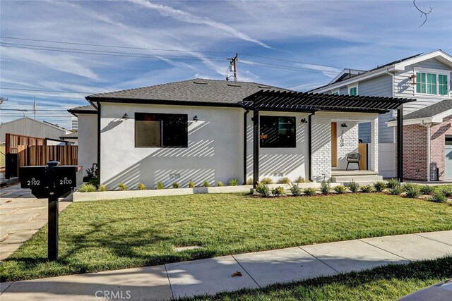 bungalow-style house featuring a front lawn and a pergola