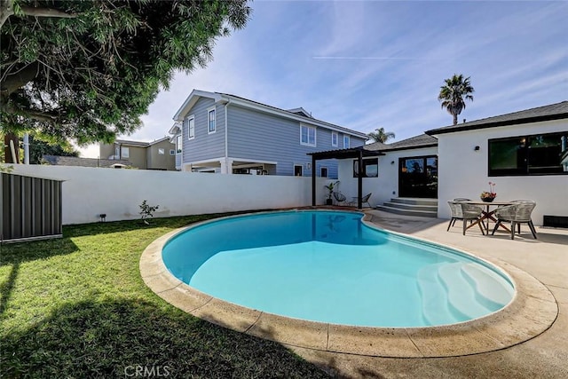 view of swimming pool with a patio area and a lawn