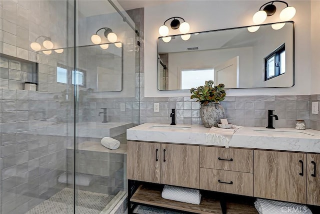 bathroom with vanity and a shower with door