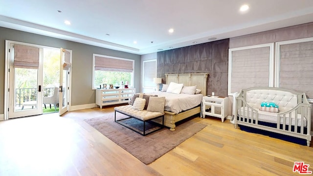 bedroom featuring access to outside and light hardwood / wood-style floors