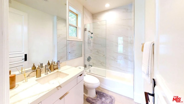 full bathroom featuring tile patterned flooring, vanity, toilet, and tiled shower / bath