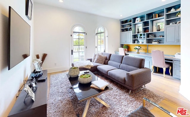 living room featuring light hardwood / wood-style flooring and built in desk