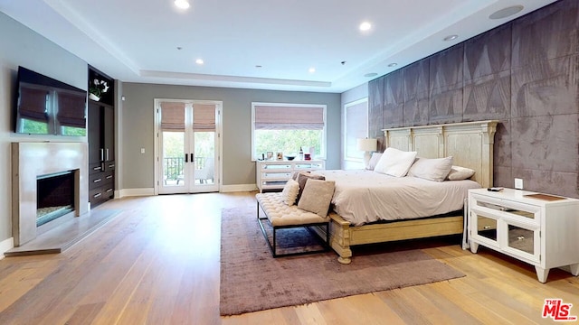 bedroom featuring french doors, light wood-type flooring, and access to exterior