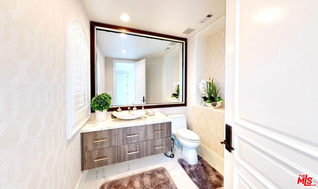 bathroom with vanity and toilet