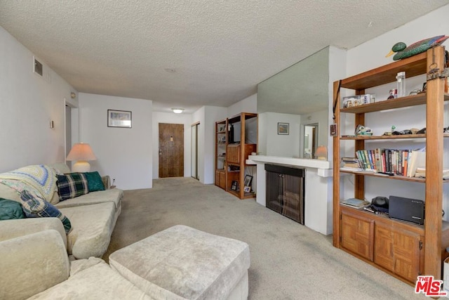 carpeted living room with a textured ceiling