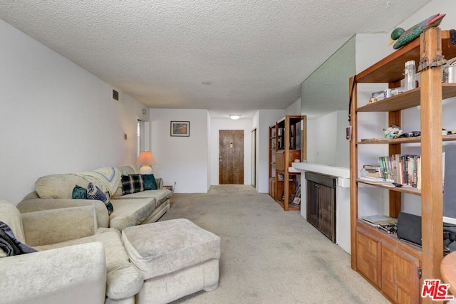 carpeted living room with a textured ceiling