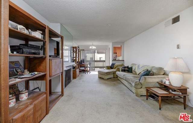 living room with light carpet and a textured ceiling