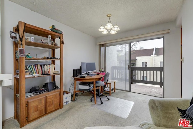 carpeted home office featuring a notable chandelier and a textured ceiling