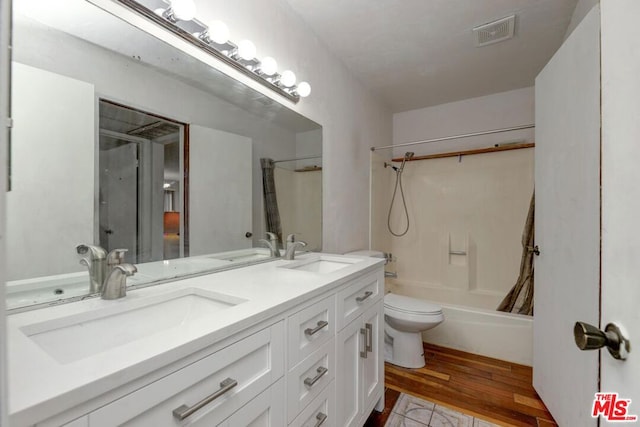 full bathroom with toilet, shower / bath combo with shower curtain, vanity, and hardwood / wood-style flooring