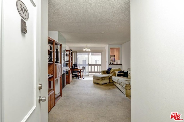 living room featuring a textured ceiling and light carpet