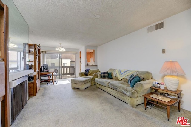 living room featuring light colored carpet and a textured ceiling