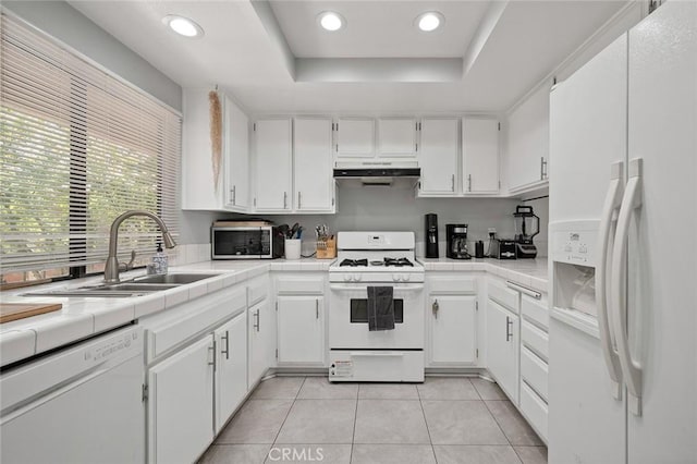 kitchen with white cabinets, white appliances, and sink