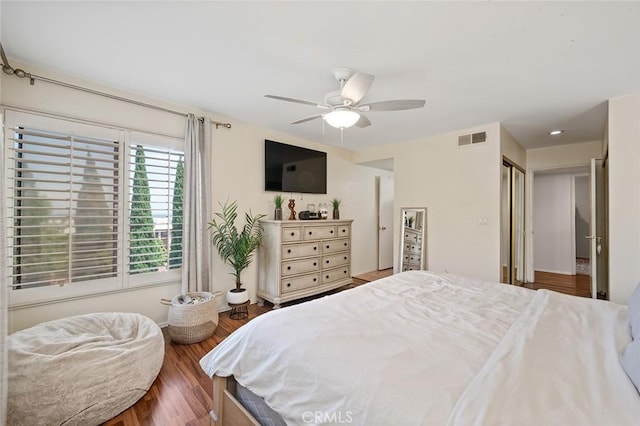 bedroom with ceiling fan, wood-type flooring, and a closet