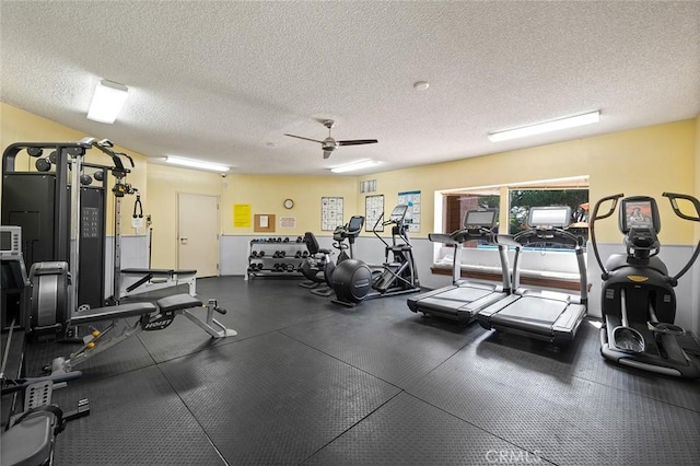 workout area with ceiling fan and a textured ceiling