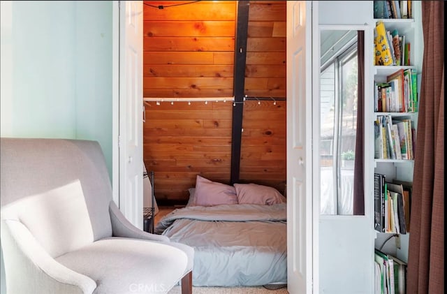 bedroom with wooden walls