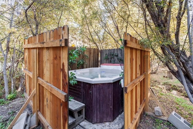 deck featuring a hot tub