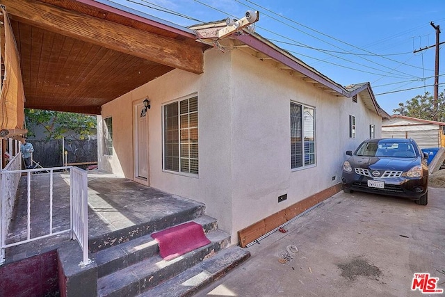 view of side of home with a patio area