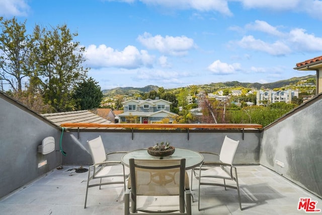 balcony with a mountain view and a patio area