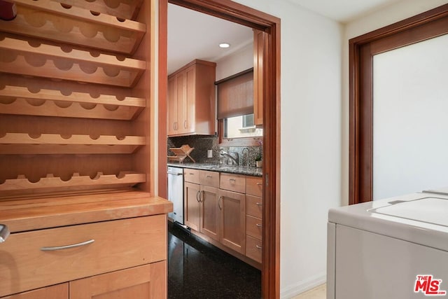 interior space with sink, backsplash, dishwasher, washer and dryer, and wood counters