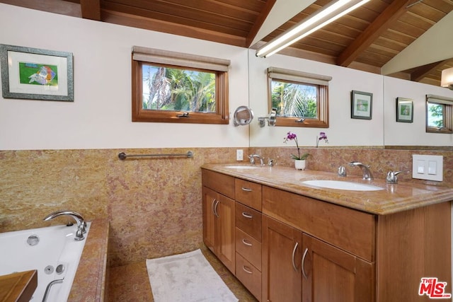 bathroom with wood ceiling, tile walls, vaulted ceiling with beams, a relaxing tiled tub, and vanity