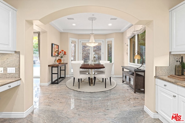 dining space featuring a tray ceiling