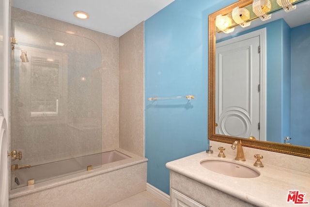 bathroom with vanity and tiled shower / bath combo