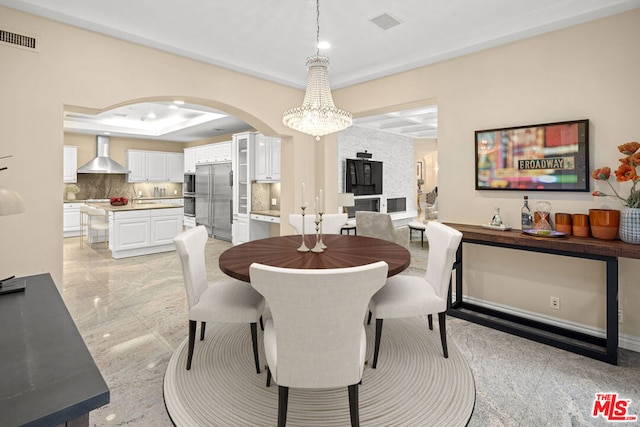 dining room featuring a tray ceiling and a chandelier