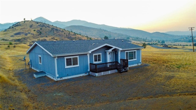 view of front facade featuring a deck with mountain view