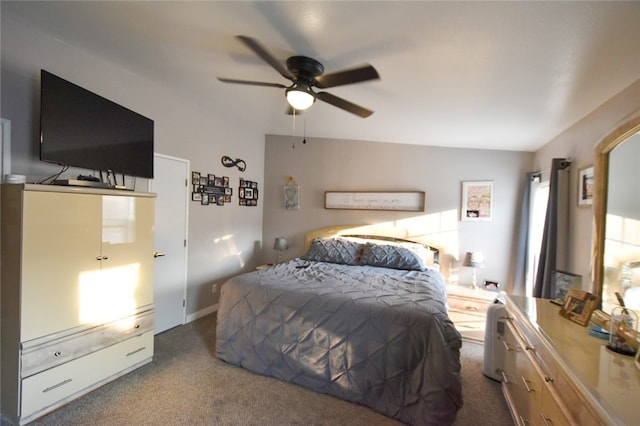 bedroom with lofted ceiling, dark colored carpet, and ceiling fan