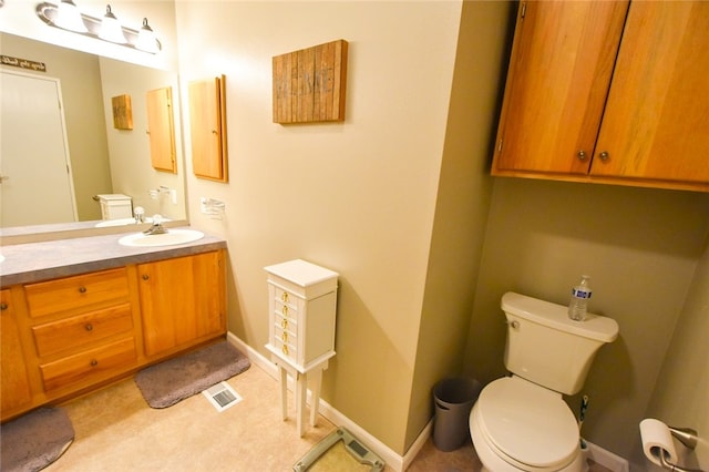 bathroom featuring vanity and toilet