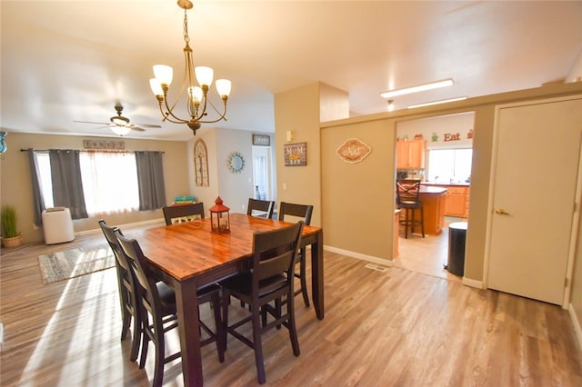 dining room featuring light wood-type flooring, ceiling fan, and a wealth of natural light