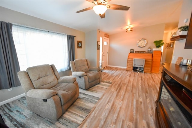 living room featuring wood-type flooring and ceiling fan