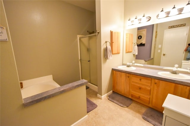 bathroom featuring a shower with door and vanity