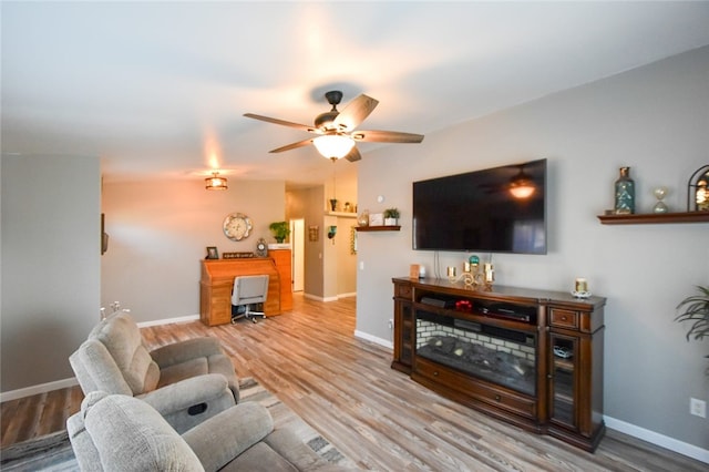 living room featuring ceiling fan and light hardwood / wood-style floors