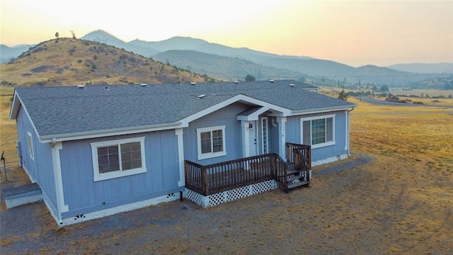 view of front facade with a deck with mountain view