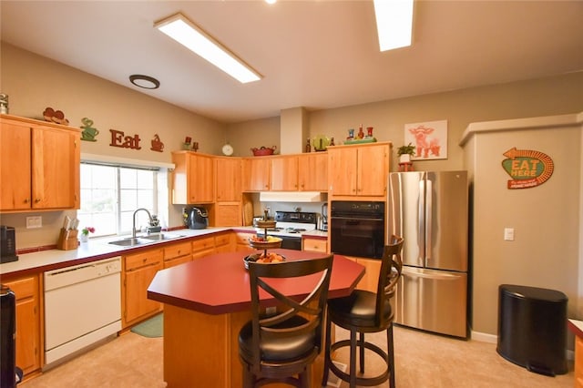 kitchen with white appliances, a kitchen island, and sink