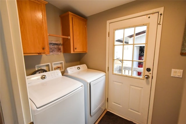 laundry area featuring cabinets and washing machine and dryer