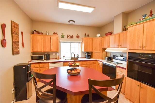 kitchen with white appliances, light brown cabinetry, and sink