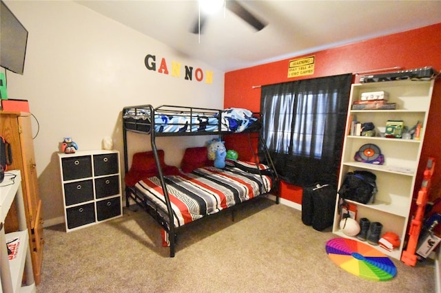 carpeted bedroom with vaulted ceiling and ceiling fan