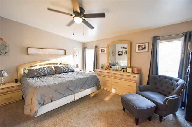 bedroom with dark carpet, lofted ceiling, and ceiling fan