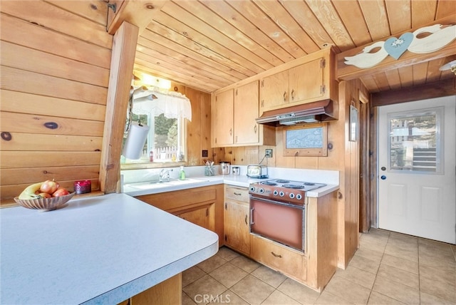 kitchen featuring wooden walls, wooden ceiling, extractor fan, light brown cabinetry, and light tile patterned floors